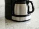 Coffee maker leaking water from the bottom onto a kitchen counter