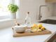 Bowl of baking soda and sliced lemons on a clean kitchen counter.