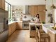 A bright modern kitchen showing a clear layout between sink stove and refrigerator.