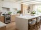 A clean white quartz countertop in a modern bright kitchen.